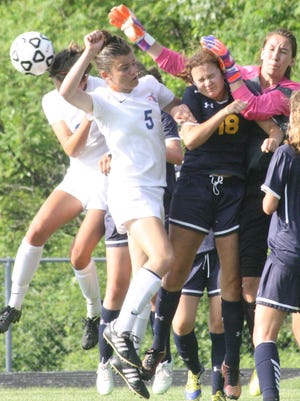 Trenton goal-keeper Christina Wynn punches away a Ladywood corner kick before Brianne Rogers (5) can get her head on it during the second half of Thursday’s game.