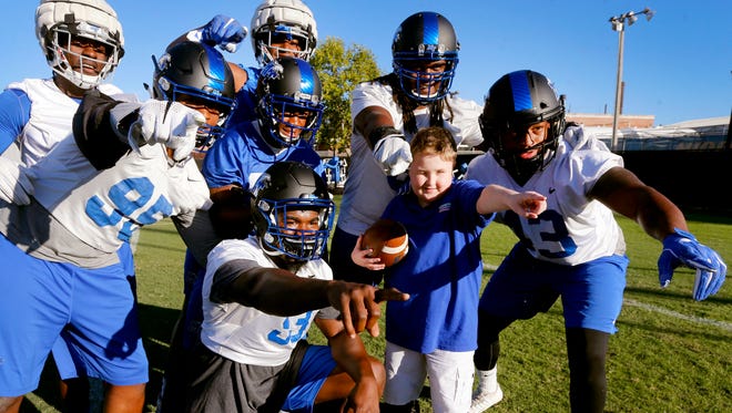 Colton Sheets has his photograph taken with several football players as Sheets visits the MTSU football team during practice on Wednesday, Oct. 18, 2017, at MTSU. Sheets will be the team's Captain during the MTSU vs Marshall football game on Friday.