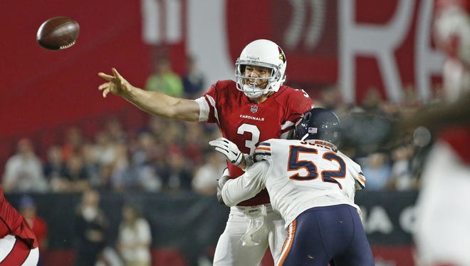 Cardinals Carson Palmer (3) throws a pass while being hit by Bears Christian Jones (52) during the first half at University of Phoenix Stadium in Glendale, Ariz. on August 19, 2017.