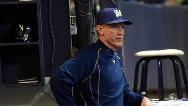 Ron Roenicke watches a game against the Cincinnati Reds.