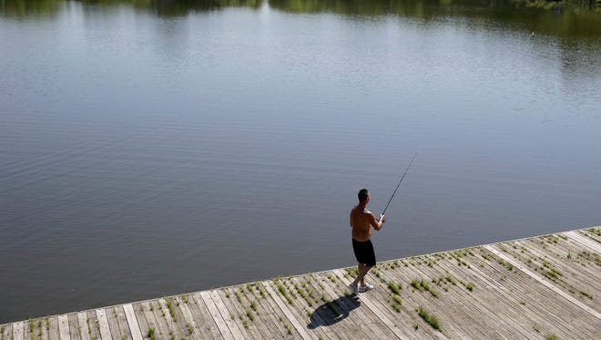 Hugh Poole fishes at a pond in FDR Park in Philadelphia, Thursday, May 24, 2018.