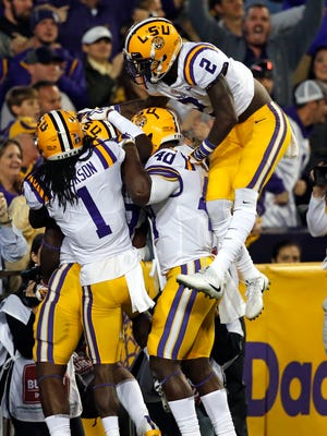 LSU players celebrate an interception during the first half of an NCAA college football game against Texas A&M in Baton Rouge, La., Saturday, Nov. 25, 2017. (AP Photo/Gerald Herbert)