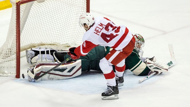 Detroit Red Wings forward Darren Helm (43) scores the game-winning shootout goal against Minnesota Wild goalie Devan Dubnyk (40) at Xcel Energy Center. The Red Wings defeated the Wild 3-2 in a shootout.