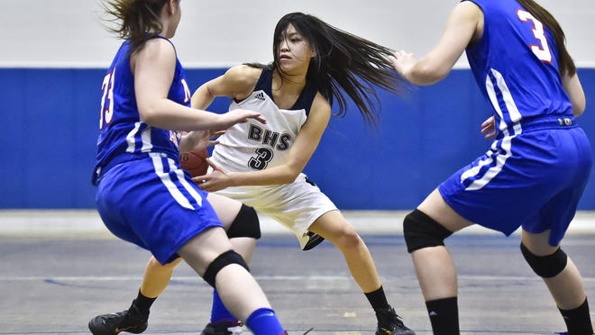 Burlington's Hien Thach (center) tries to get past Mt. Anthony's Emily Hutton (left) and Madison Little in Burlington on Tuesday, December 23, 2014.
