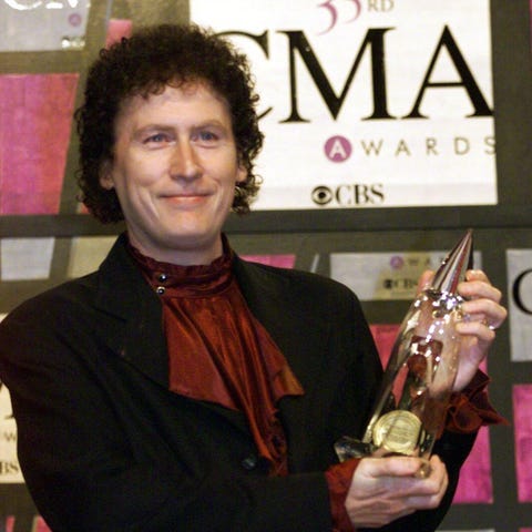 Randy Scruggs holds his award at the 1999 CMA...