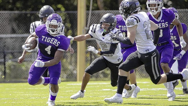 Pickerington Central's Nick Mosley heads upfield ahead of Pickerington North's Brian Dickerson on Aug. 30. The Tigers won the nonl-eague game 35-9 and will play at Newark on Friday, Sept. 4.