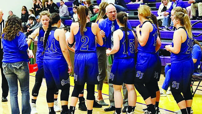 St. John coach Danny Smith encourages his team during sub-state action last week. The Tigers defeated South Gray, one of the best teams in 1A basketball, before dropping a hard-fought game to Ingalls.