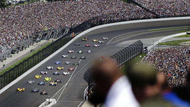 Fans watch as the green flag is waved during the 100th running of the Indianapolis 500 at Indianapolis Motor Speedway on May 29, 2016.