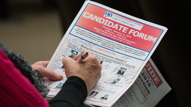COURTNEY SACCO/CALLER-TIMES
An attendee of the League Of Women Voters Candidate Forum at City Hall takes notes during the final remarks for the candidates, Thursday, Feb. 11, 2016.