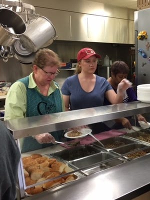 Elizabeth Walker, right, volunteers in the City Lights soup kitchen two days a week.