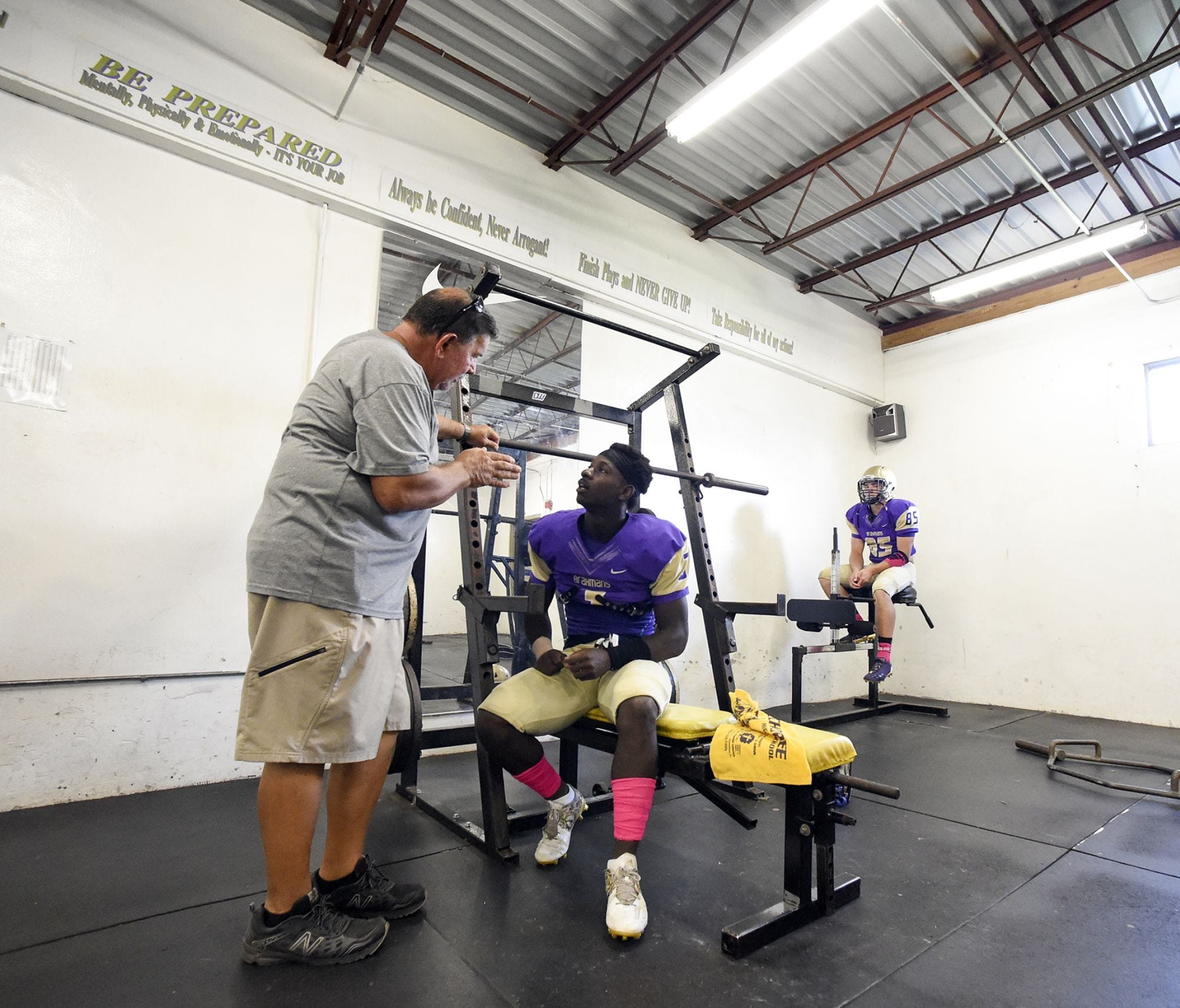 Okeechobee High School assistant coach Glenn Attaway talks with running back/defensive end JaJuan Cherry Monday, Oct. 16, 2017, in the locker room before their team's high school football game against Sebastian River at Okeechobee High School.