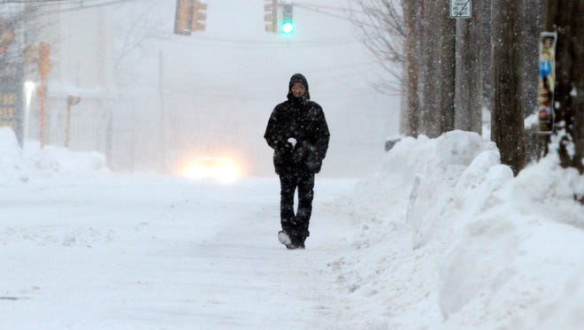 Mike Graham walks on a snow-covered street on Feb. 9 in Marlborough, Mass.