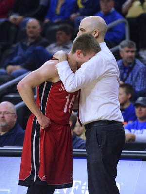 USD's Casey Kasperbauer (14) gets a hug from head coach, Craig Smith, in the final minute of their 86-70 loss to Fort Wayne in a Summit League basketball men's quarterfinal Saturday at the Denny Sanford Premier Center, Mar 5, 2016.