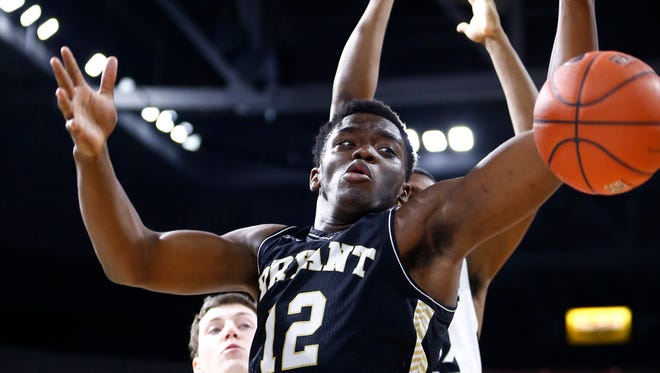 Bryant University forward Marcel Pettway goes after a rebound against Providence during a game last season.