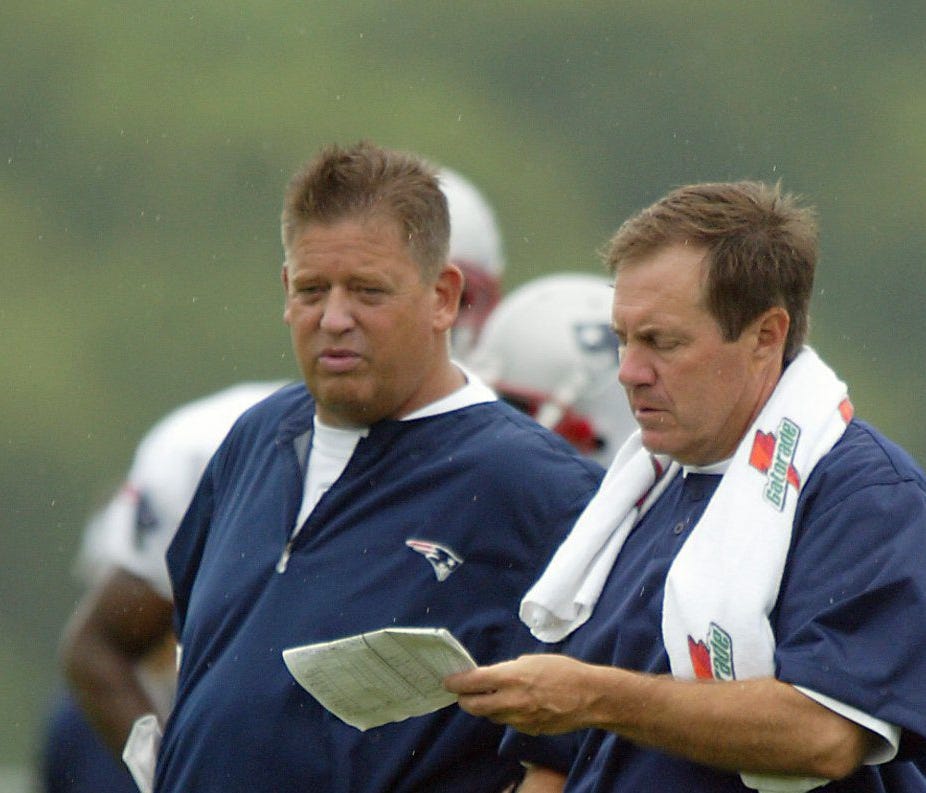 New England Patriots' head coach Bill Belichick, right, goes over plays with offensive coordinator Charlie Weis, left, during training camp, Sunday, Aug. 1, 2004, in Foxboro, Mass. (AP Photo/Stew Milne) ORG XMIT: RISM102