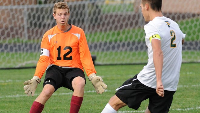 De Pere High School goalie Dane Steger (12) was forced way out of goal to stop a breakaway by Max Starks (2) against Preble High School at Gauthier Family Stadium September 8, 2015. Steger stopped Starks' shot.