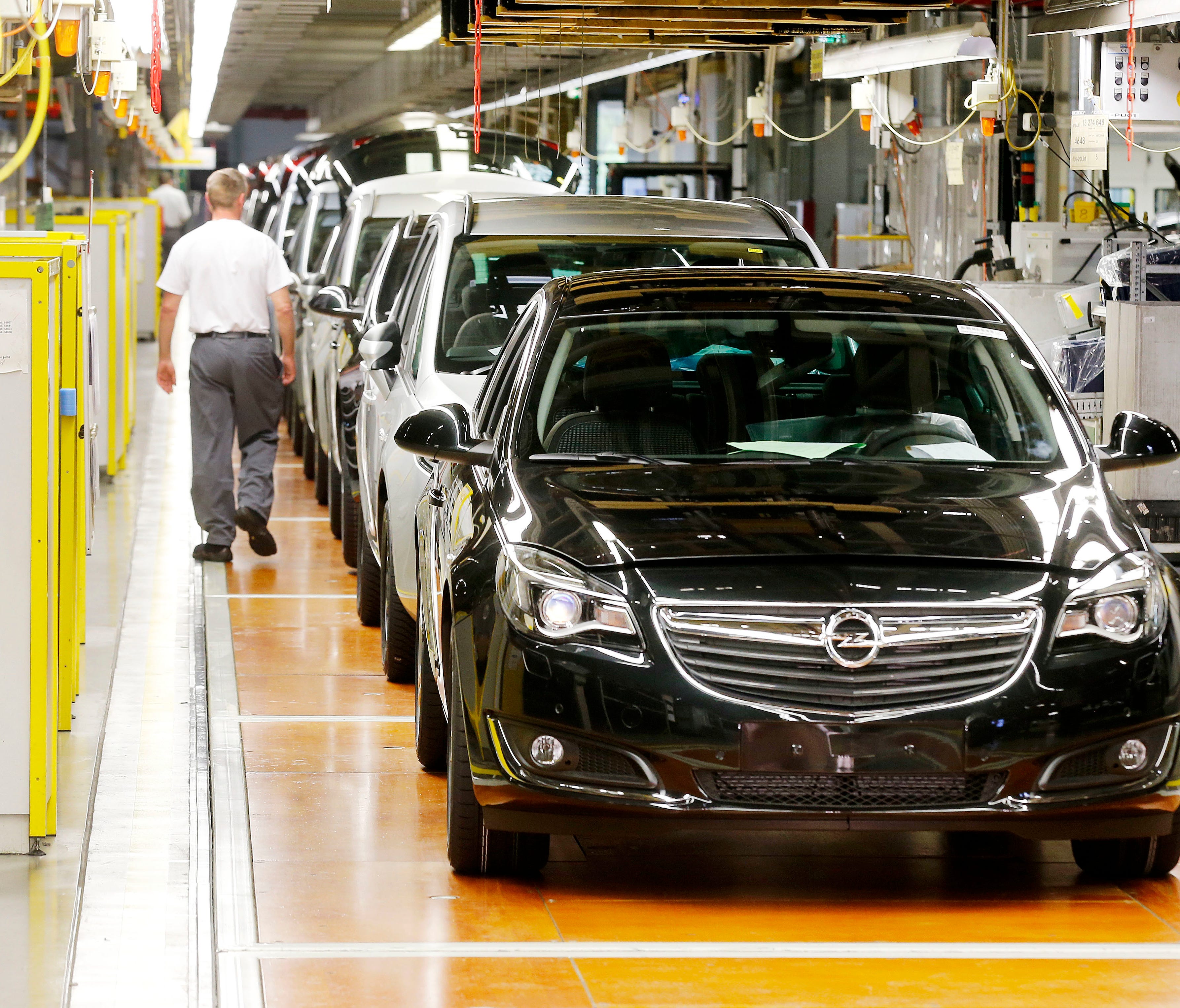 Opel cars stand on the assembly line in the Opel car manufactory in Ruesselsheim, Germany. European automakers Opel and Vauxhall say there'll be no forced layoffs and all of their current plants will be maintained as they look to a new future under F