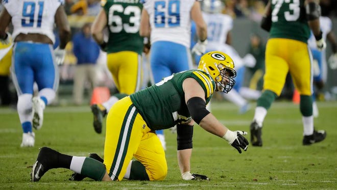 Green Bay Packers offensive tackle Bryan Bulaga (75) gestures to the bench after going down hurt on a play against the Detroit Lions in the third quarter at Lambeau Field on Monday, November 6, 2017 in Green Bay, Wis.