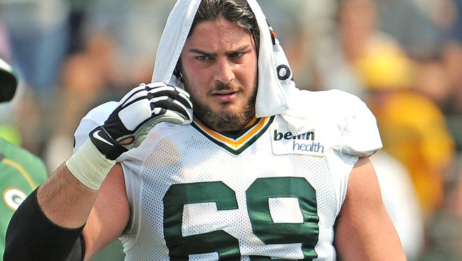 Offensive tackle David Bakhtiari (69) cools off with a wet towel during Green Bay Packers Training Camp at Ray Nitschke Field September 1, 2015.