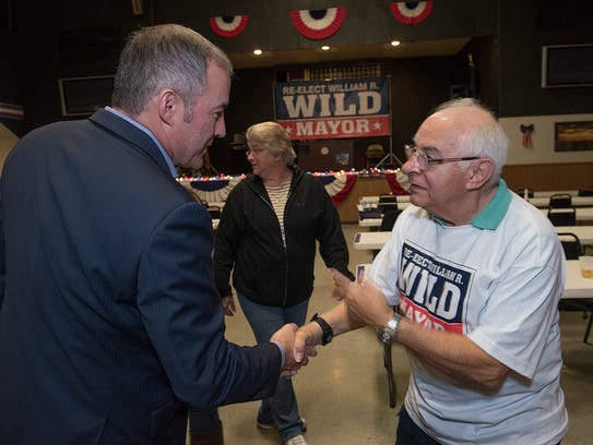 Mayor William Wild speaks with supporter Regis Miller.