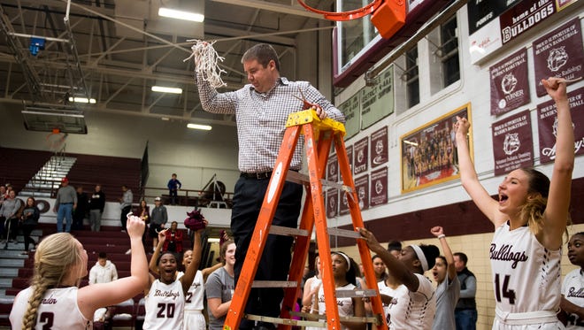 Bearden players cheer after coach Justin Underwood cuts down the net after the Class AAA sectional game against Jefferson County on Saturday.