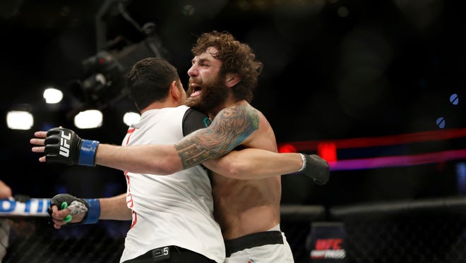 Michael Chiesa (blue gloves) reacts after defeating Beneil Dariush (red gloves) in the lightweight bout (bout 7) during UFC Fight Night at Amalie Arena.