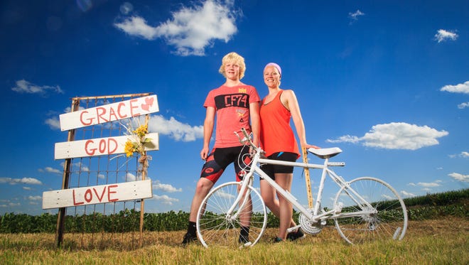 Siblings Issac and Hannah Harken stand at the ghost bike in memory of their sister Grace outside Osage Tuesday, July 17, 2018. The Bike marks the spot where Grace Harken was hit and killed by a distracted driver in 2015.