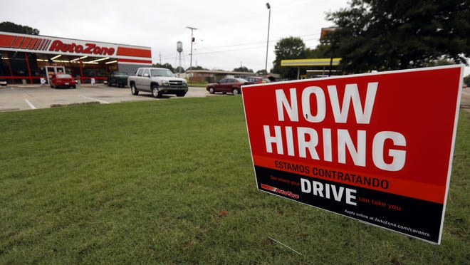 FILE- In this Sept. 27, 2018, file photo a bilingual help wanted sign for Auto Zone, a retailer of aftermarket automotive parts and accessories, is posted outside the store in Canton, Miss. Another healthy picture of hiring is expected when the U.S. government issues its September jobs report Friday, Oct. 5. (AP Photo/Rogelio V. Solis, File)