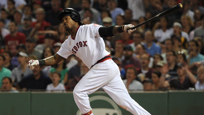 Boston Red Sox first baseman Hanley Ramirez (13) hits a two run home run during the sixth inning against the San Francisco Giants at Fenway Park.