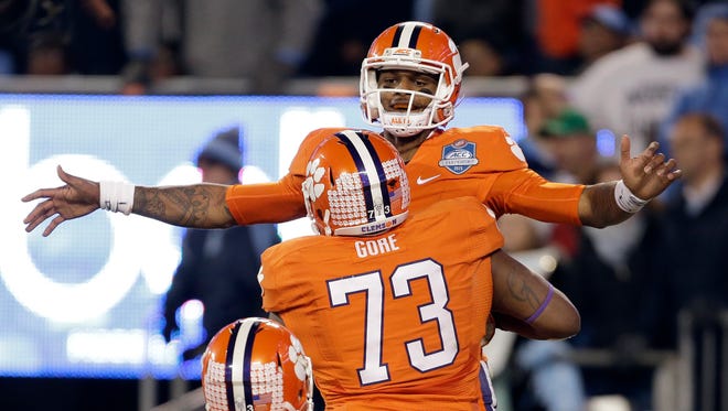 Clemson quarterback Deshaun Watson celebrates his touchdown with Joe Gore (73) during the first half of the Atlantic Coast Conference championship NCAA college football game against North Carolina in Charlotte, N.C., Saturday, Dec. 5, 2015. (AP Photo/Bob Leverone)