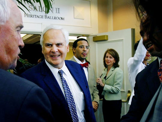 FedEx founder Fred Smith, middle left, arrives to speak during the Southern Heritage Classic's Coaches Luncheon at the Memphis Marriott Downtown Sept. 15, 2006.