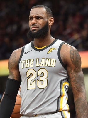 Cleveland Cavaliers forward LeBron James (23) reacts after a play during the second half against the San Antonio Spurs at Quicken Loans Arena.