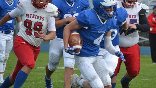 Inland Lakes senior running back Beau Vizina (4) runs during a contest against Charleton Heston Academy in Indian River earlier this season. The Bulldogs are scheduled to play at Suttons Bay in a MHSAA 8-Player Division 1 state semifinal on Tuesday, Dec. 15, at 7 p.m.