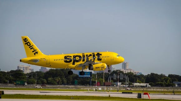 Exterior of landing Spirit A319 in bright yellow livery.