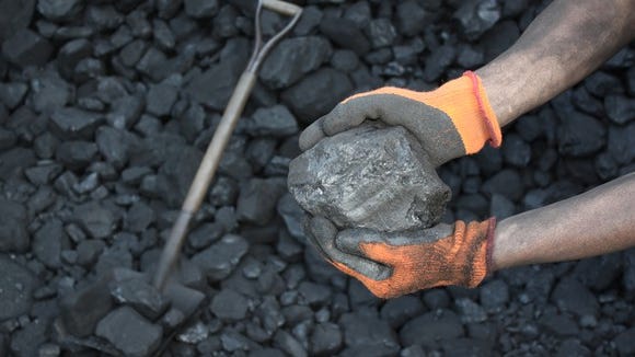 Coal in the hands of a miner.
