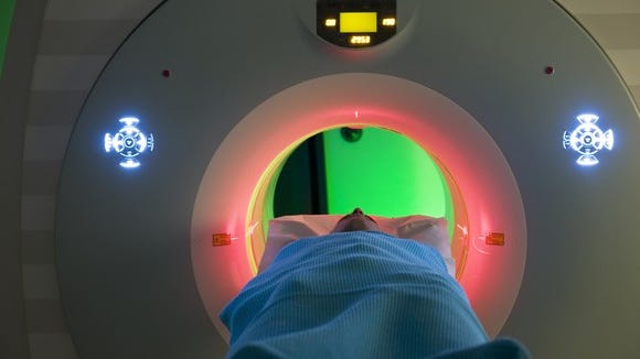Patient going into an MRI with various colors and displays.