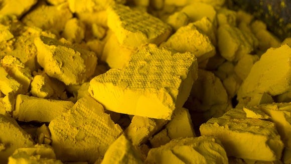 A heap of yellow uranium cakes.