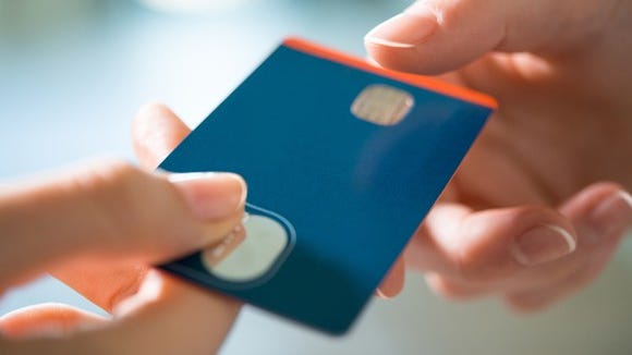 credit card being passed between two hands