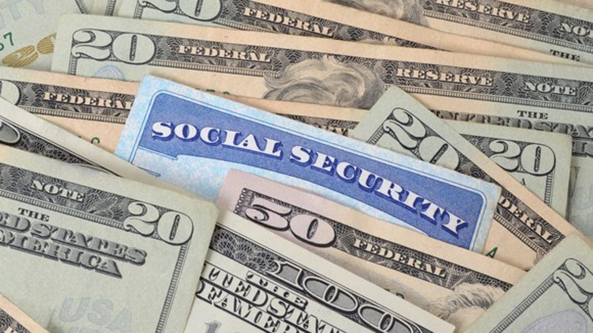 Social Security card in a pile of cash.