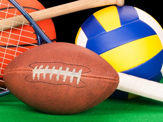Arrangement of assorted sports equipment on black background