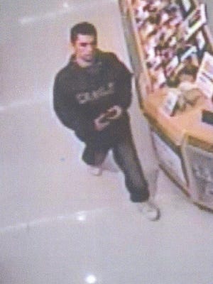 A male suspected of theft at Walmart is pictured inside the store.