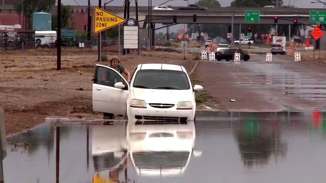 Driver gets stuck on flooded street