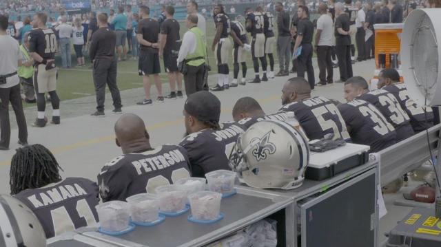 Group of Saints Players Sit During National Anthem