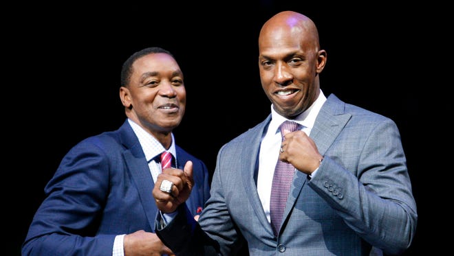 Former Nuggets guard and Denver native Chauncey Billups, right, walks by Isiah Thomas during his retirement ceremony in Detroit in 2016. The Nuggets should hired Billups as their GM, columnist Mark Knudson writes.