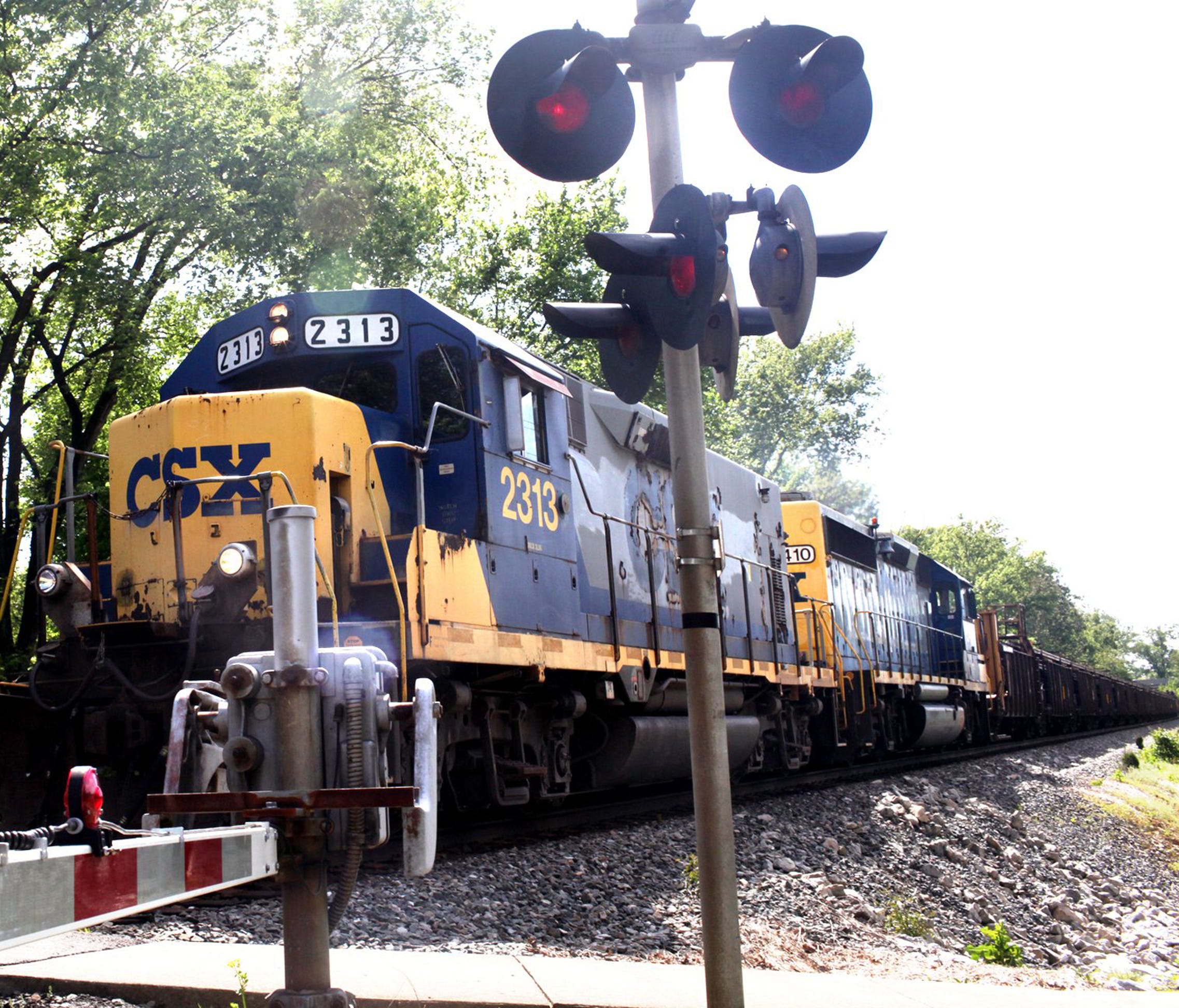 A CSX train approaches an at-grade crossing April 23, 2012, in the Louisville suburb of St. Matthews, Ky.