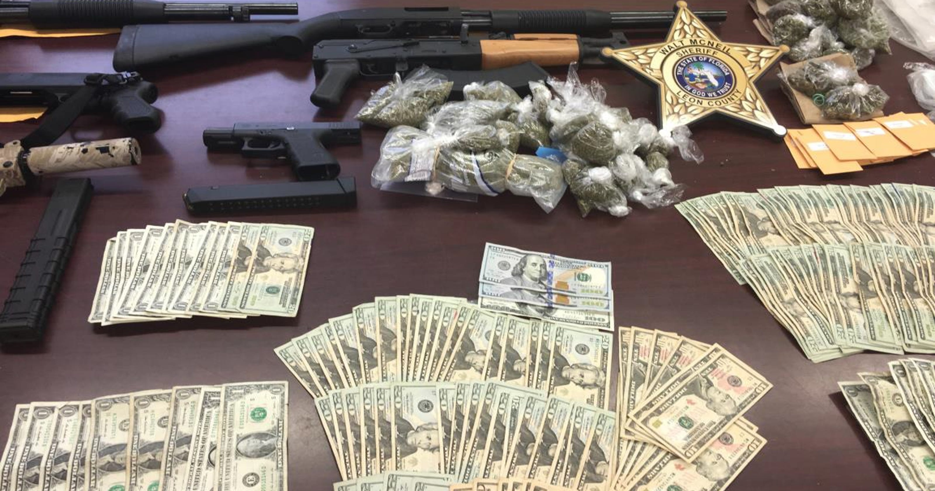 Guns, drugs and cash seized in apartment raid