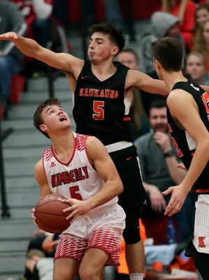 Kimberly High School's Alec Rosner (5) puts up a shot against Kaukauna High School's Jordan McCabe (5) and Dylan Kurey (32) during their boys basketball game Friday, December 8, 2017, in Kimberly, Wis. Dan Powers/USA TODAY NETWORK-Wisconsin
