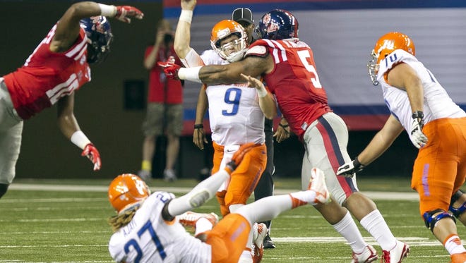 Boise State quarterback Grant Hedrick is hit byMississippi defensive tackle Robert Nkemdiche during an NCAA college football game, Thursday Aug. 28, 2014 in Atlanta. (AP Photo/The Idaho Statesman, Darin Oswald)  LOCAL TELEVISION OUT (KTVB 7); MANDATORY CREDIT