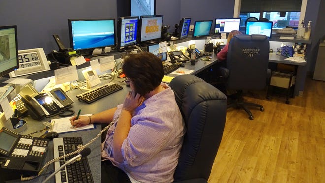 Karen Schroeder, a senior dispatcher at the city 911 center, takes a call on Thursday afternoon. The Zanesville Police Department installed a new digital 911 system. Run by Experient, the system will eventually allow callers to text to 911 dispatchers or send video.
