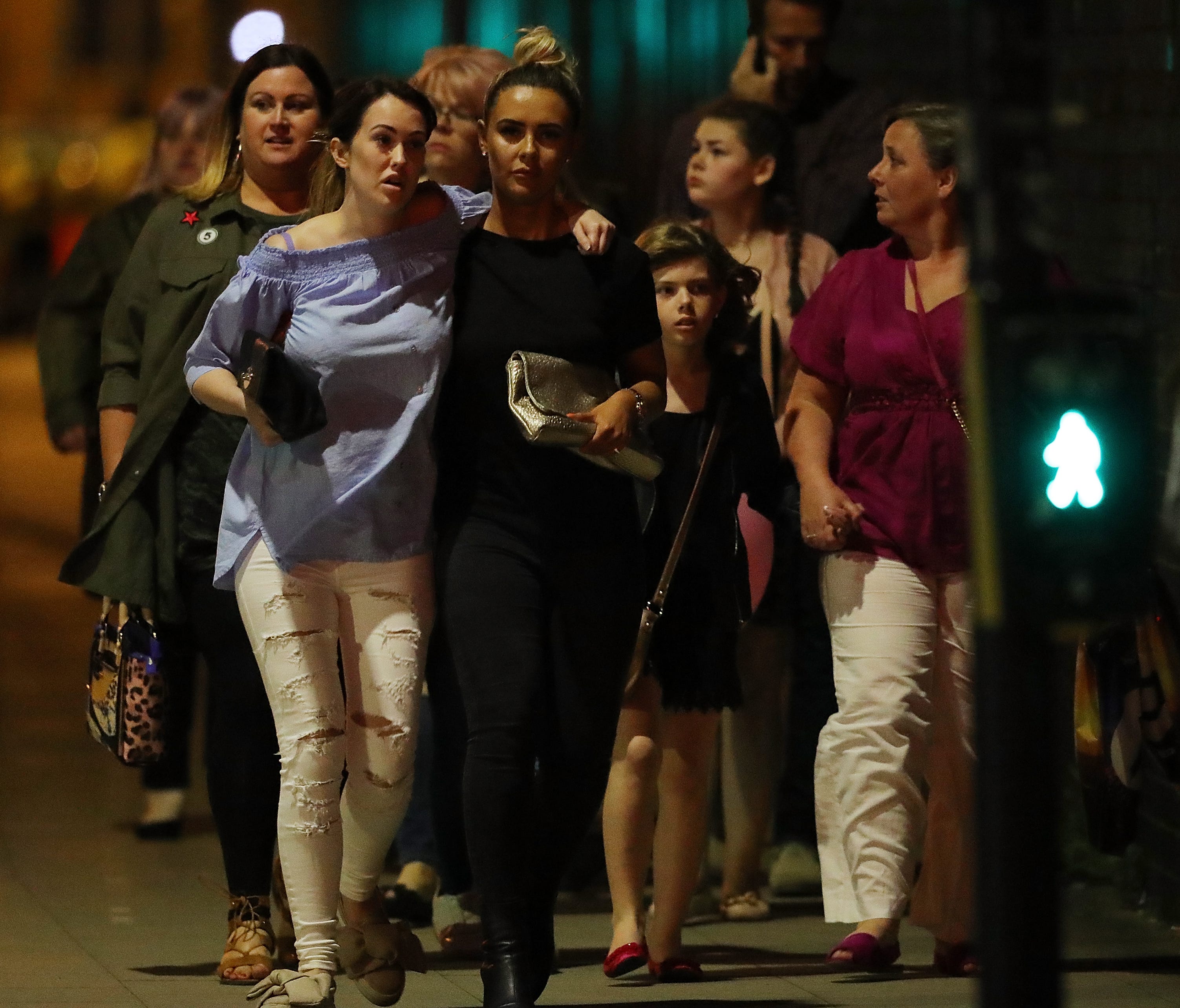 Police escort members of the public from the Manchester Arena on May 23, 2017 in Manchester, England.